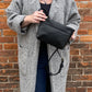 Studio pothos Cosmos bag in black with brass hardware.