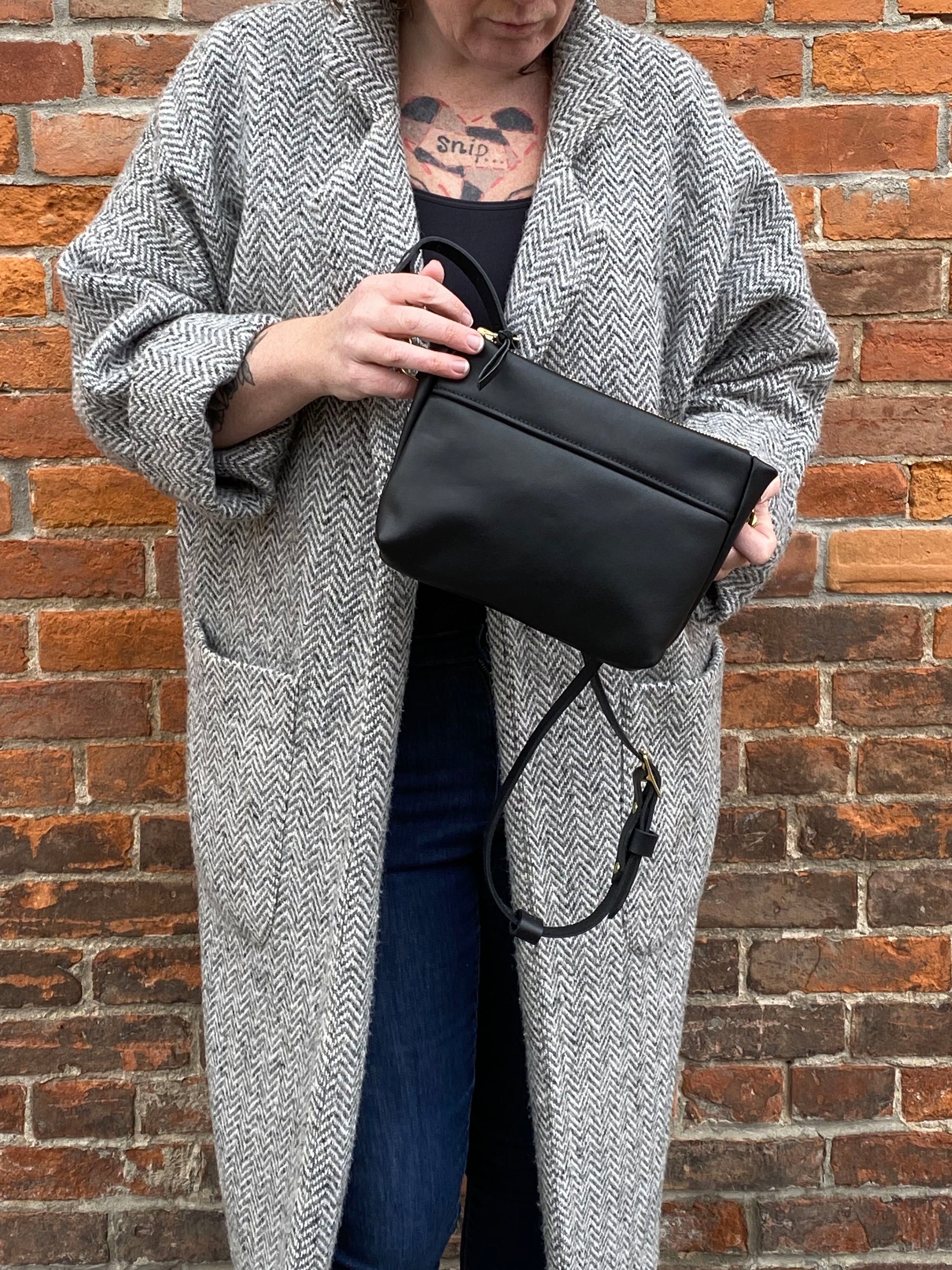 Studio pothos Cosmos bag in black with brass hardware.