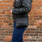 Studio pothos Cosmos bag in black with brass hardware, with long strap